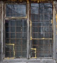 Old wooden window behind a metal grate. Vintage texture Royalty Free Stock Photo