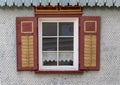 Old wooden window with blinds and curtains. Scenic original and colorful view of antique windows Royalty Free Stock Photo