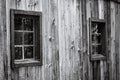 Old wooden window covered with spiders web on the old wooden wall. Wooden old window with dirty windows and full of cobwebs.