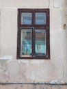 The old wooden window on the cracky wall