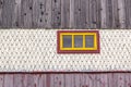 Old wooden window on facade house with tiles wood pattern