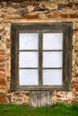 An old wooden window with glass, a fragment of an old manor. Royalty Free Stock Photo
