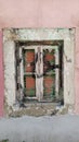 An old wooden window with old white paint is boarded up with bricks Royalty Free Stock Photo