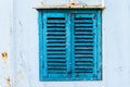 Old wooden window painted blue with rusty lock. Texture, wall of an old wooden house with shuttered windows, painted blue. Royalty Free Stock Photo