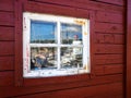 Old wooden window of a red wood house Royalty Free Stock Photo