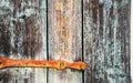 Detail of an old wooden shutter with metal hinge