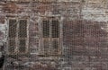 Old wooden window with shutters on the netted house wall Royalty Free Stock Photo