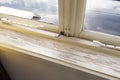 Old wooden window sill with cracked peeling paint and durt, needs renovation and repaired, replaced Royalty Free Stock Photo