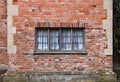 Old wooden window in a weathered brick wall in an old manor house Royalty Free Stock Photo