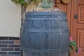 Old wooden wine barrel with rustic decoration. Old wine cellar walls. The concept of traditional winemaking and modern