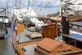 Old wooden yachts moored in the sea marina. Wooden deck of a sailing ship and mast, sails rolled up