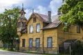 Old wooden yellow house with small tower during sunny day in summer in Riga, Latvia Royalty Free Stock Photo