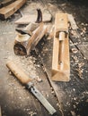 Old woodworking hand tool: wooden plane, chisel and in a carpentry workshop on dirty rustic table covered with sawdust