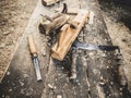 Old woodworking hand tool: wooden plane, chisel and drawing knife in a carpentry workshop on dirty rustic table covered Royalty Free Stock Photo