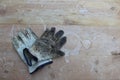 Old work gloves on a weathered wood table Royalty Free Stock Photo