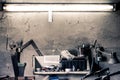 Old work tools, shelf on a wall over an old vintage workbench in a home garage Royalty Free Stock Photo