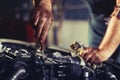 Worker repairs a car in a car repair center