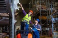 Workers in logistics warehouse at forklift checking list. Royalty Free Stock Photo