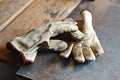 Old working gloves over wooden table, on a metal woodworking machine construction tools, gloves for each finger Royalty Free Stock Photo