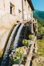 Old working watermill wheel with falling water Royalty Free Stock Photo