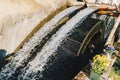 Old working watermill wheel with falling water Royalty Free Stock Photo