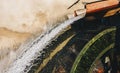 Old working watermill wheel with falling water Royalty Free Stock Photo