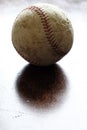 Old Worn Baseball on Wood with Backlight Royalty Free Stock Photo