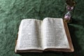 old worn bible and pink quartz timer Royalty Free Stock Photo