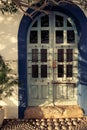 Old and worn blue wooden door with glass and ironwork in Ibiza island - Image Royalty Free Stock Photo