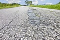 Old worn and cracked damaged asphalt road surface background Royalty Free Stock Photo