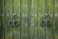 Old and worn double-leaf door with metal knockers Royalty Free Stock Photo