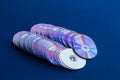 Old DVDs lined up on blue cloth. Royalty Free Stock Photo