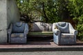 Old Worn Furniture Left in Front of an Old House wall