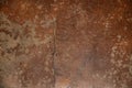 Old worn grungy cracked earth tone painted concrete floor background with brush marks and scratches Royalty Free Stock Photo