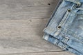 Old worn jeans over a wooden background Royalty Free Stock Photo