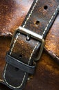 Old worn leather bag buckle detail