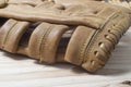 Old worn leather baseball glove on a wooden Royalty Free Stock Photo