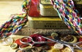 OLD WORN METAL PIN BOXES WITH COLORFUL THREAD BRAID, BUTTONS AND SCISSORS Royalty Free Stock Photo