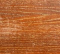 Old worn orange wooden surface with peeling varnish