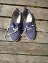 Old worn out and dirty blue sneakers Royalty Free Stock Photo