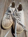 Old worn out and dirty white sneakers Royalty Free Stock Photo