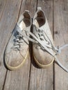 Old worn out and dirty white sneakers Royalty Free Stock Photo