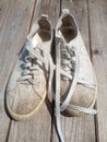 Old worn out and dirty white sneakers Royalty Free Stock Photo