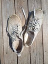 Old worn out and dirty white sneakers Royalty Free Stock Photo