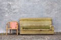 Worn-out furniture against a gray brick wall, Beijing, China