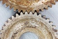 old worn out gear cogwheels with rust on scratched metal background