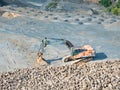 Old worn out loader between piles of crushed basalt stones Royalty Free Stock Photo