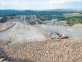 Old worn out loader between piles of crushed basalt stones Royalty Free Stock Photo