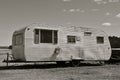 Old worn out pull camper black and white