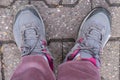 old worn-out shoes, hiking boots on female foot on floor, signs of wear and tear, adding to character, Poverty and Homelessness, Royalty Free Stock Photo